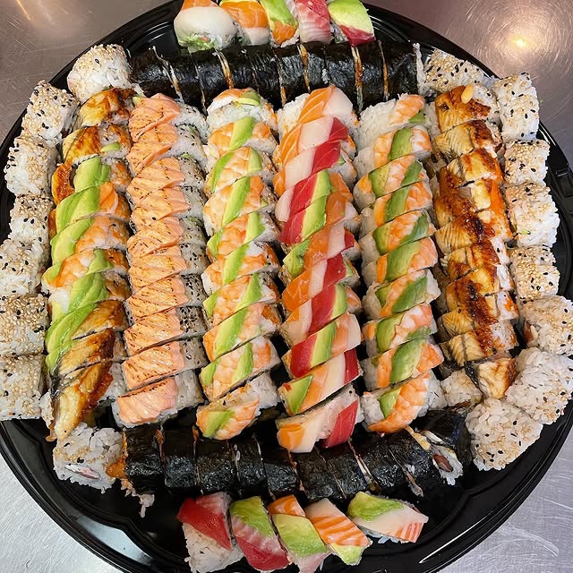 Sushi Joe sashimi platter with tuna, salmon, and hamachi on a handcrafted ceramic plate